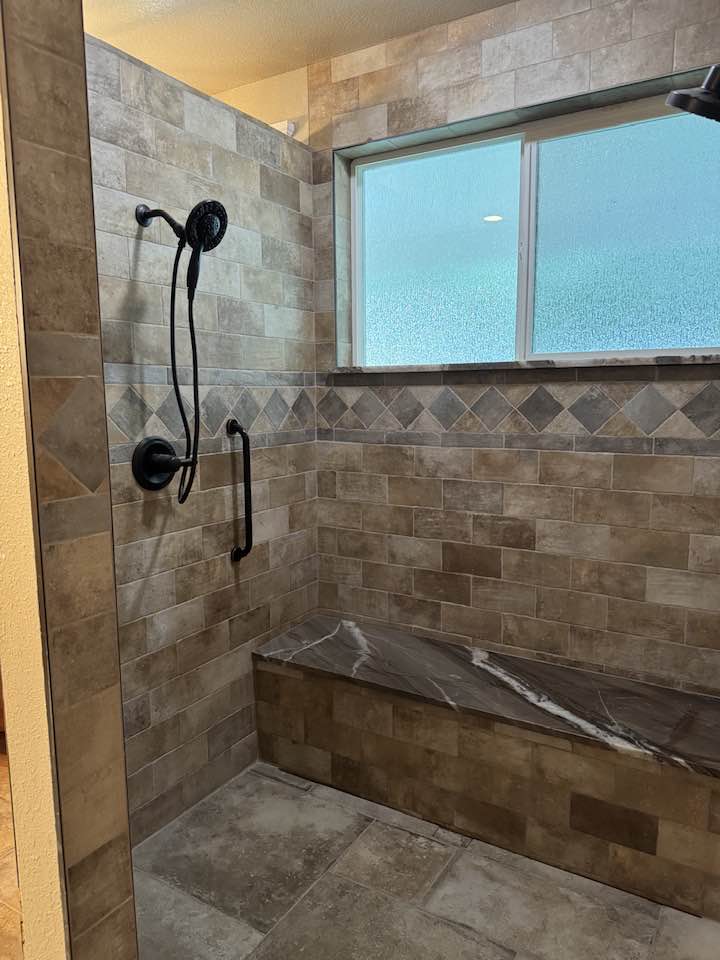 Newly retiled shower with warm floor added to the tile flooring.
